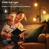 Woman reading a book to a child on a couch with warm lighting.